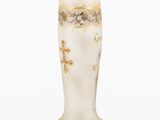a white vase with a gold decoration on it