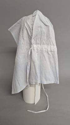 white apron on a mannequin head on a grey background
