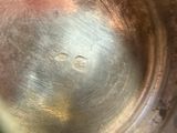 a close up view of a metal bowl with a hole in it