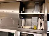 a kitchen with a microwave, microwave oven, and other appliances in it