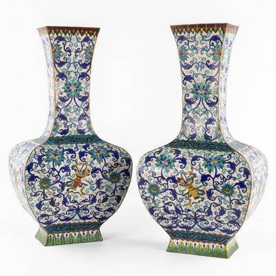 pair of blue and white vases with birds and flowers on them