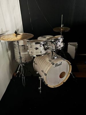 a drum set up in the corner of a room