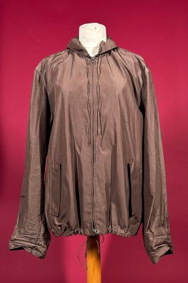 jacket on a mannequin stand against a red background