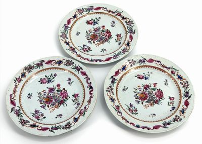 three plates with floral designs on them on a white surface