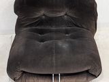 a chair that is sitting on the floor in front of a wall