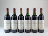 six bouteilles de vin sont alignées sur une surface blanche
