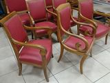 six red chairs sitting in a room with a white tile floor