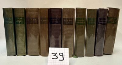 several old books are lined up on a table with a price tag