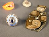 many different types of jewelry on display on a table