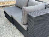 a couch that is sitting on the concrete ground