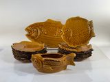 five pieces of pottery that are sitting on a table