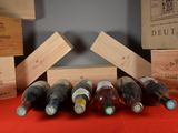 several bottles of wine are stacked on top of each other on a table