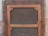 an old wooden door with a glass window on the side of a building