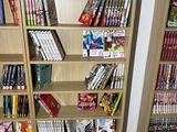 two bookshelves that are filled with comic books