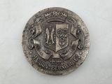 an old silver coin with a coat of arms and a crown on it