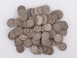 a pile of silver coins on a white surface