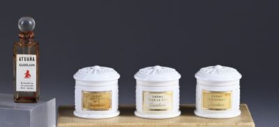 three jars and a bottle of liquor on a wooden stand