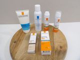 bottles of sunscreen and lotion sitting on a wooden tray on a table