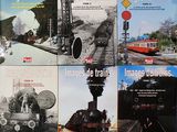 quatre livres posés sur une table, avec des images de trains sur la couverture