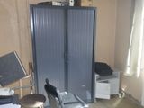 an image of a room with a chair and a cabinet