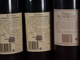 several bottles of wine are lined up on a shelf