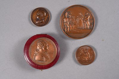several coins and a coin with a picture of a man on it