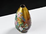 a vase with a floral design on it on a white surface