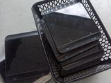 a lot of laptops in a basket on the floor