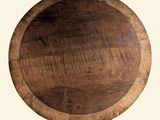 a wooden plate with a wooden handle on a table