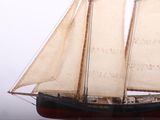 a small model of a sailboat on a table