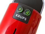 a close up of a red coffee maker with buttons on it