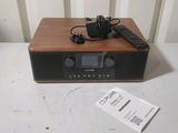 a radio with a remote and a remote control on a table