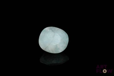 an image of a white stone on a black surface