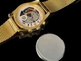 a watch that is sitting next to a coin