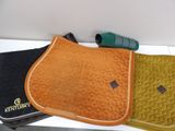 three saddle pads and a pair of binoculars sitting on a table