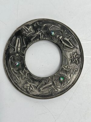 Cadre de forme rond en bois et étain à décor repoussé de feuillages et