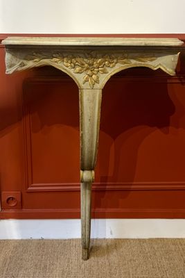 a small table with a vase on top of it