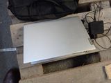 a laptop sitting on top of a pallet with a bag