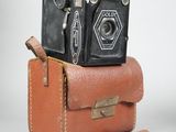 two old cameras sitting on top of each other