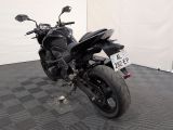 a picture of a black motorcycle parked on a checkered floor
