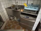 a kitchen with a sink, dishwasher, and dishwasher in it