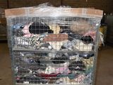 a cart with a lot of clothes on it in a warehouse