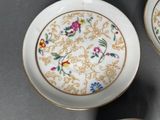 two plates with flowers on them sitting on a table