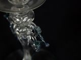 a glass candle holder with a candle on top of it