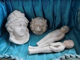 a statue of a woman laying on a blue blanket