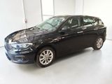the small black car is parked in a large room