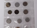 a lot of coins in a plastic case on the table