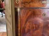a wooden cabinet with a marble top in a living room