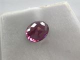 a close up of a pink diamond on a white surface