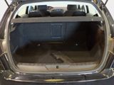 the back of a car with its trunk open and the back seat down